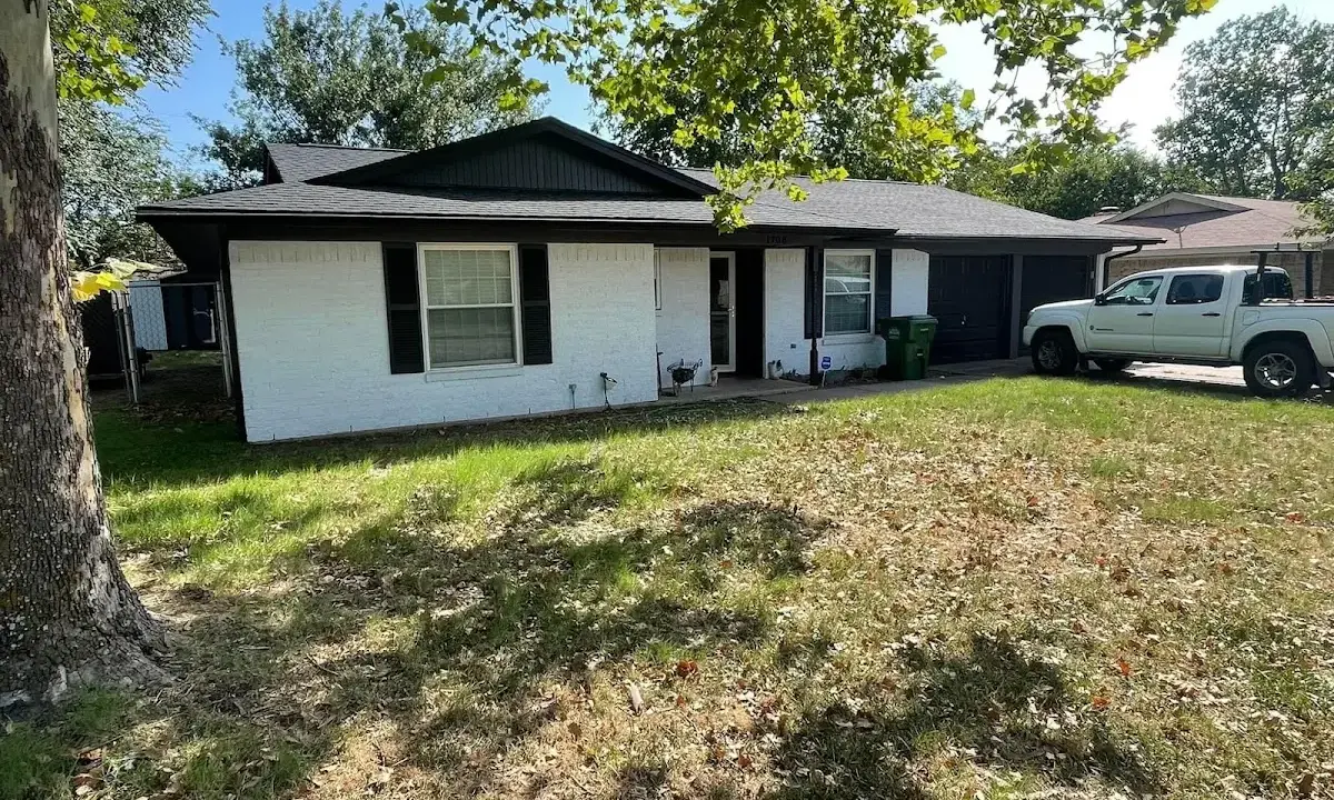 Professional roofing crew working on a residential roof in Malverne
